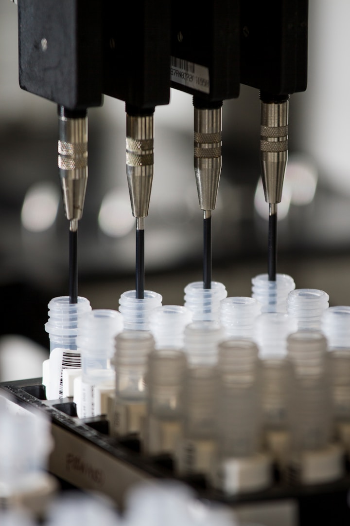 Multiple robotic pipettes dispensing liquids into small clear containers.